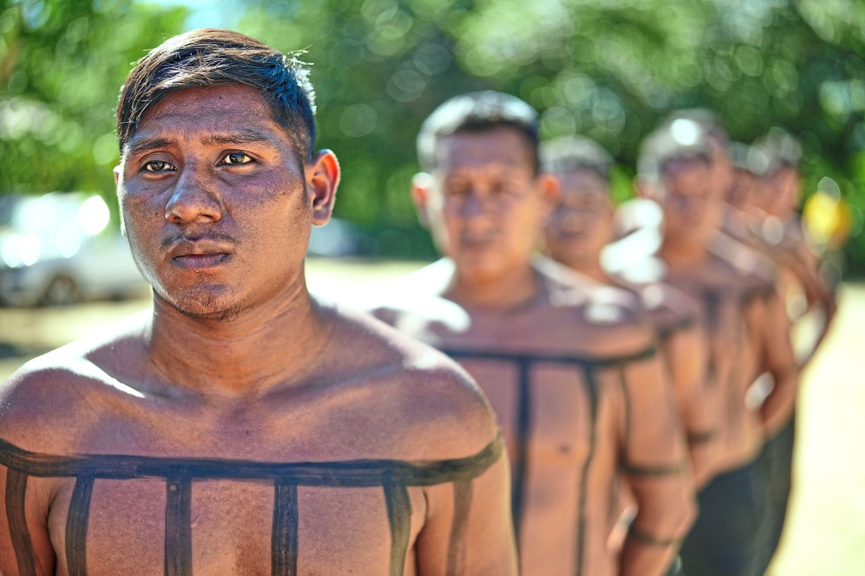 Xerente Indigenous firefighters stand during a fire prevention operation along Brazil's environmental protection agency, IBAMA, at the Xerente territory, near Tocantinia, Tocantins state, Brazil, Tuesday, May 19, 2026. (AP Photo/Andre Penner)