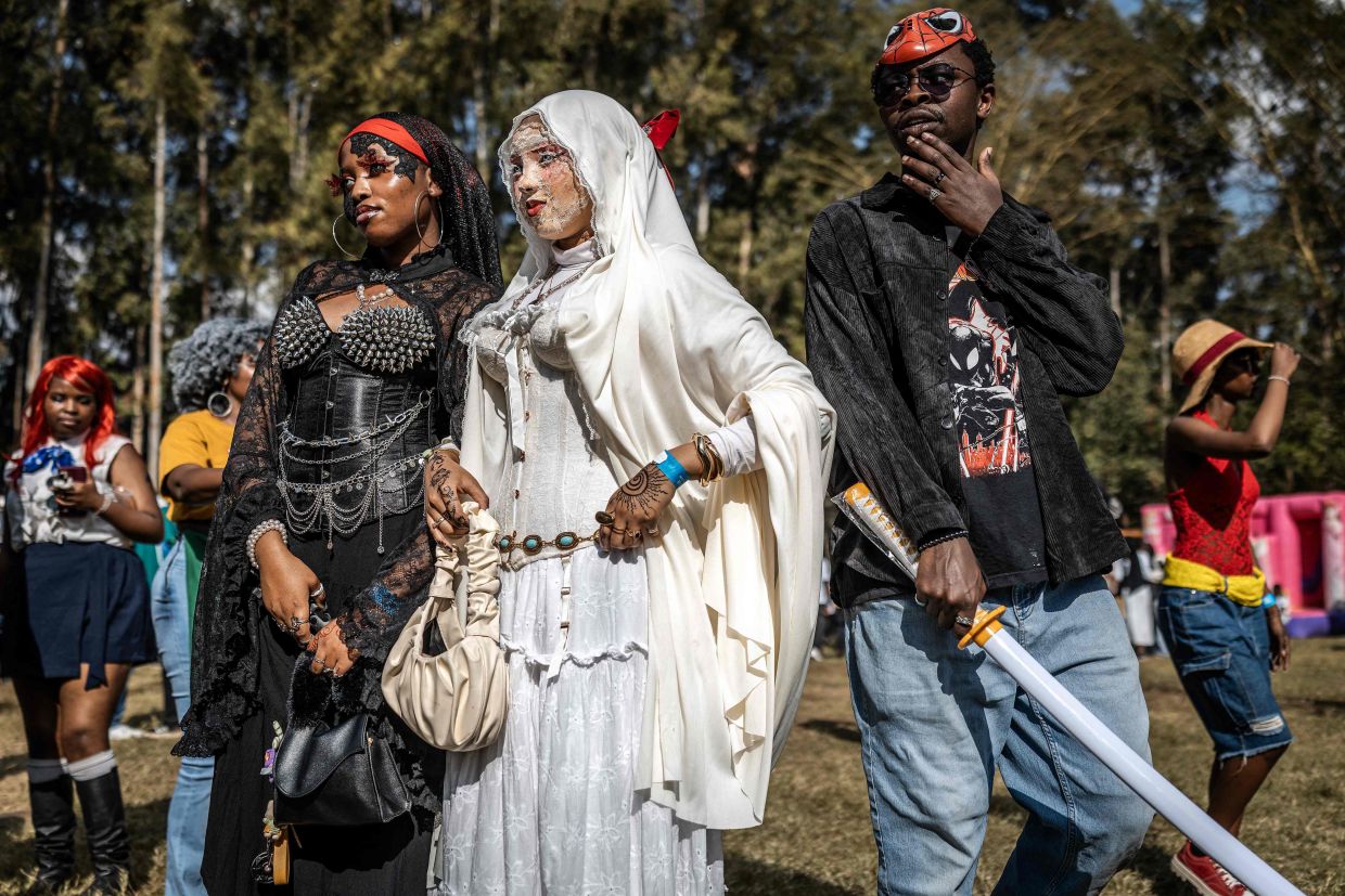 Young fans wearing fashion creations inspired by Japanese anime characters walk together during the Otamatsuri convention in Nairobi on Aug 22. Photo: AFP