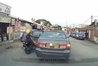 Two injured as motorcycle crashes into suddenly opened car door