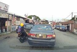 Two injured as motorcycle crashes into suddenly opened car door