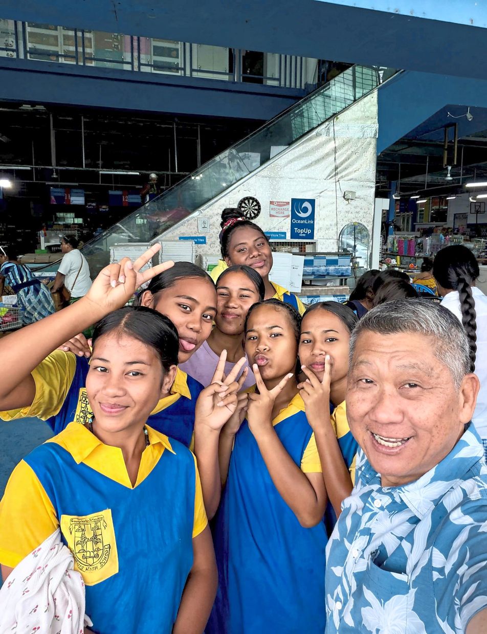 The columnist (right) with some students at Kiribati, a country in Micronesia.