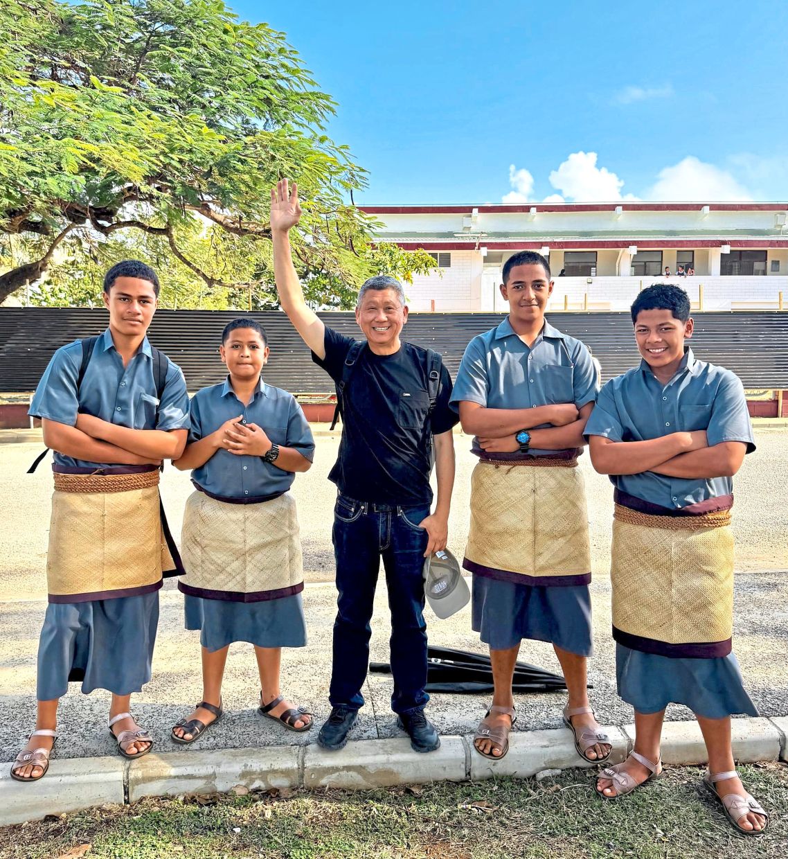 The writer (centre) with male students of the Tonga High School wearing the traditional ta’ovala, a woven mat tied around the waist. 