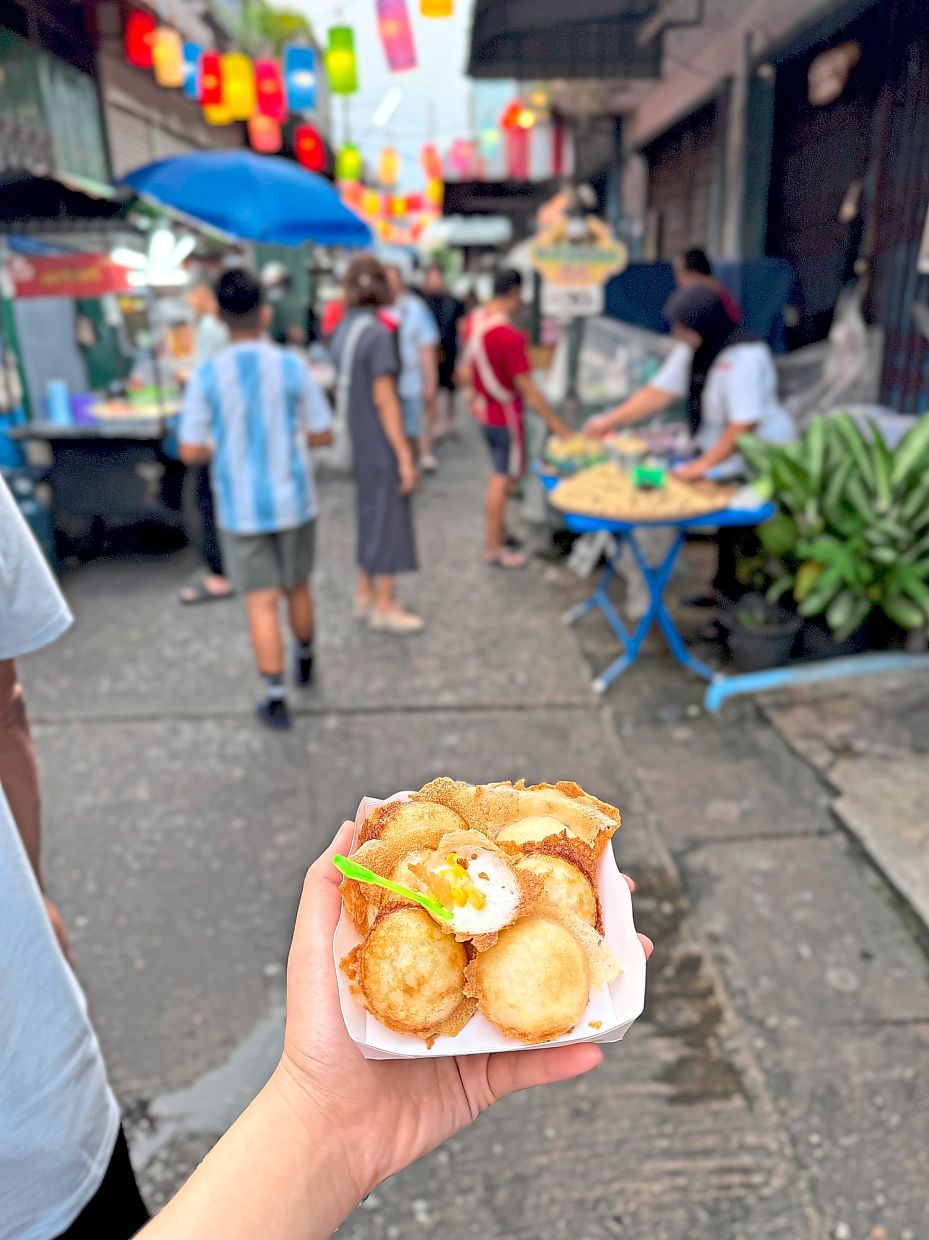 Kanom krok, bite-sized coconut pancake, is a popular Thai street snack.