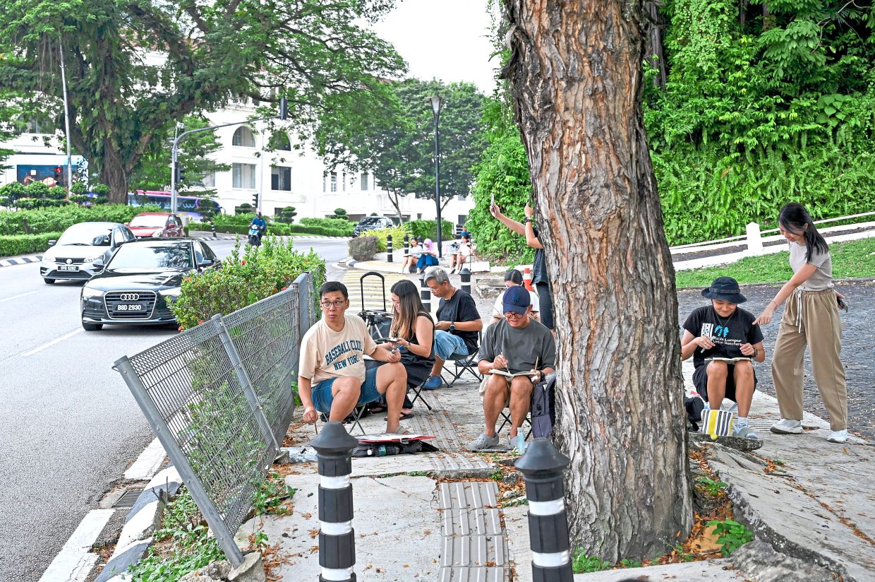 A group of artists from the Kuala Lumpur and Klang chapters of Urban Sketchers pick a spot under a shady tree on Jalan Sultan Hishamuddin for a good view of the Kuala Lumpur Railway Station building.