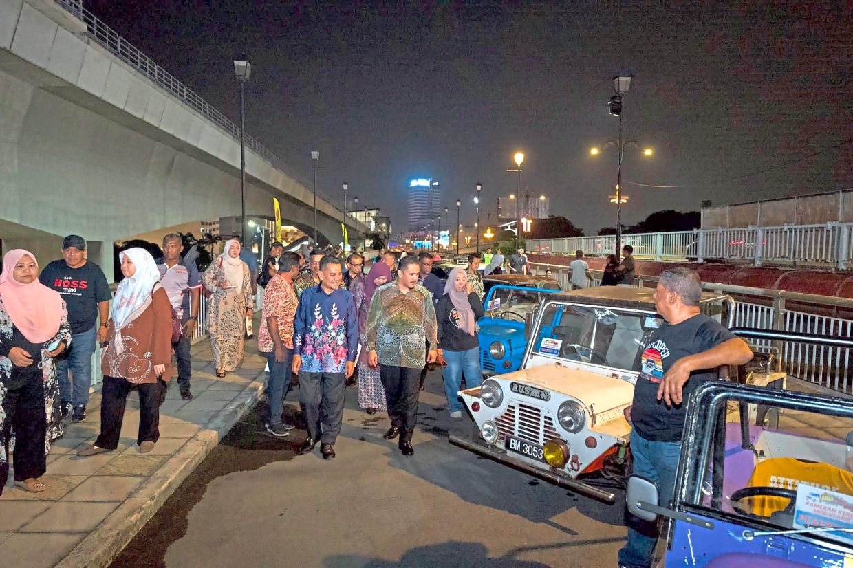 Car enthusiasts checking out the Saturday market, with part of the bridge’s upper deck hosting classic cars such as Mini Moke. — Courtesy of MBDK