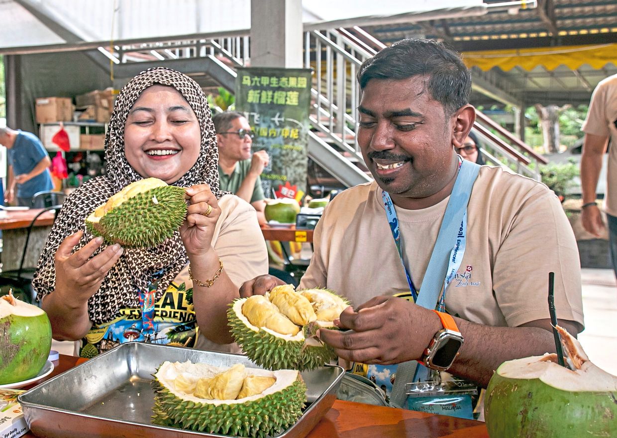 Participants enjoying a variety of durian at the event in Bemban, Melaka.