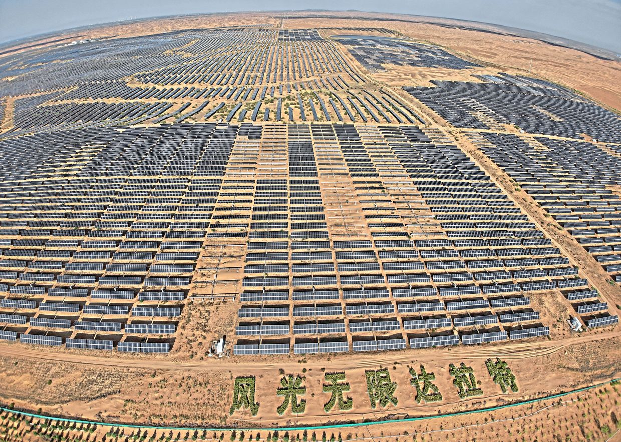 Solar panels at the Dalad Banner Photovoltaic Top Runner Base. — AP
