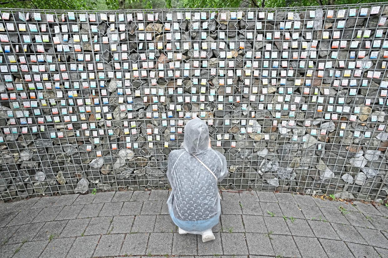 South Korean adoptees longing for their birth mothers leave names on a park wall