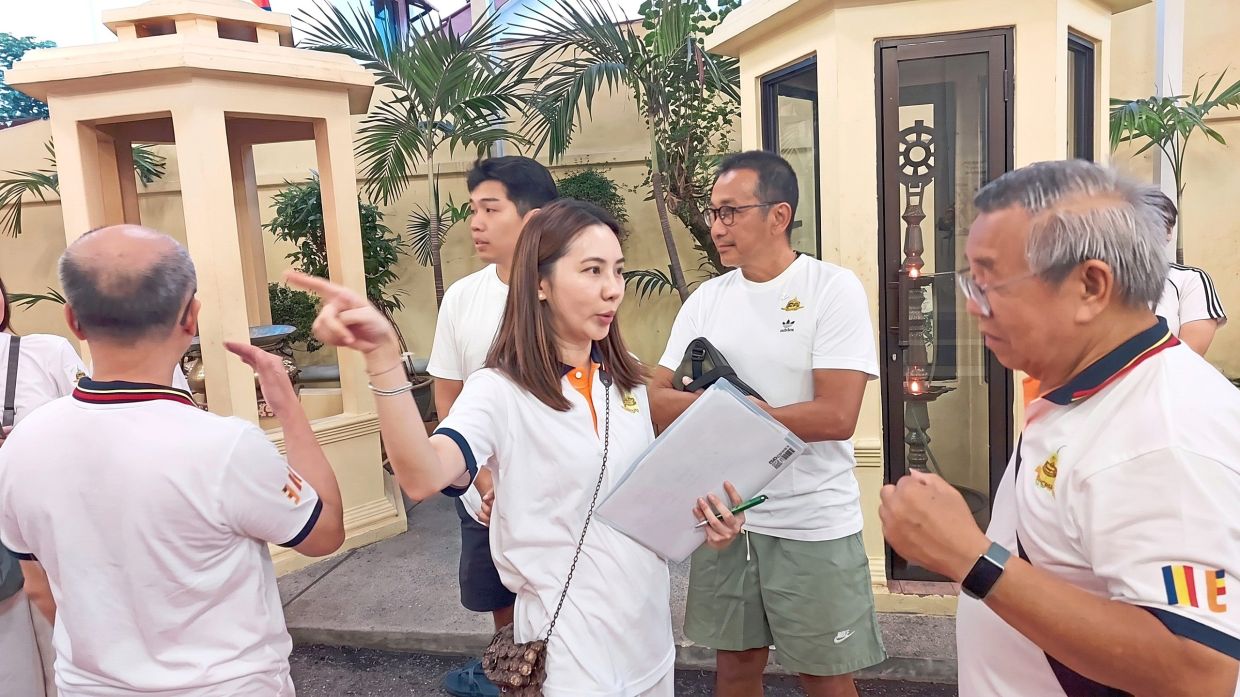 Loh (centre) sparing time to serve at Mahindrama Buddhist Temple. — Courtesy of Tiffany Loh