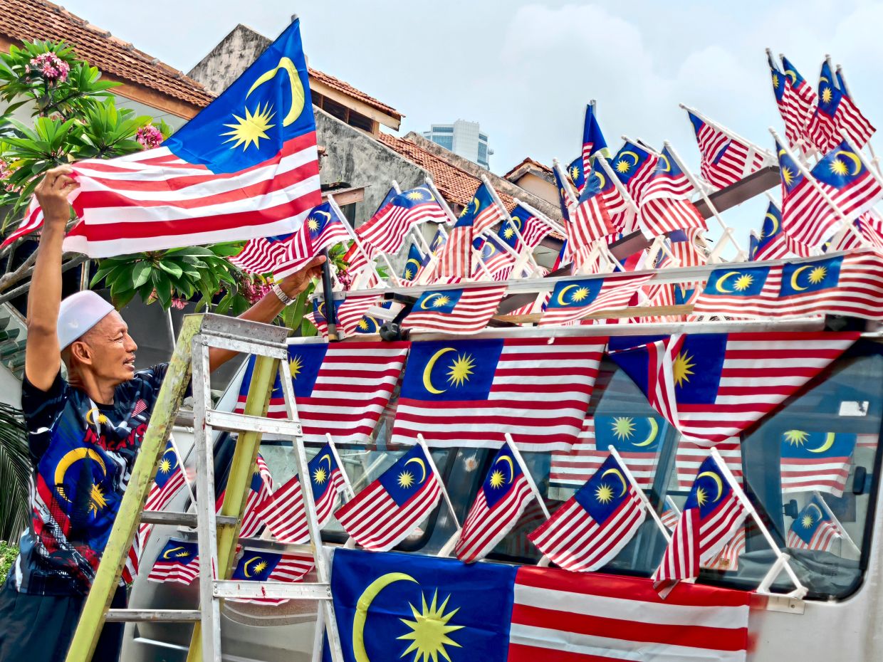 Indonesian-born’s daily ‘flag parade’ wins hearts around town