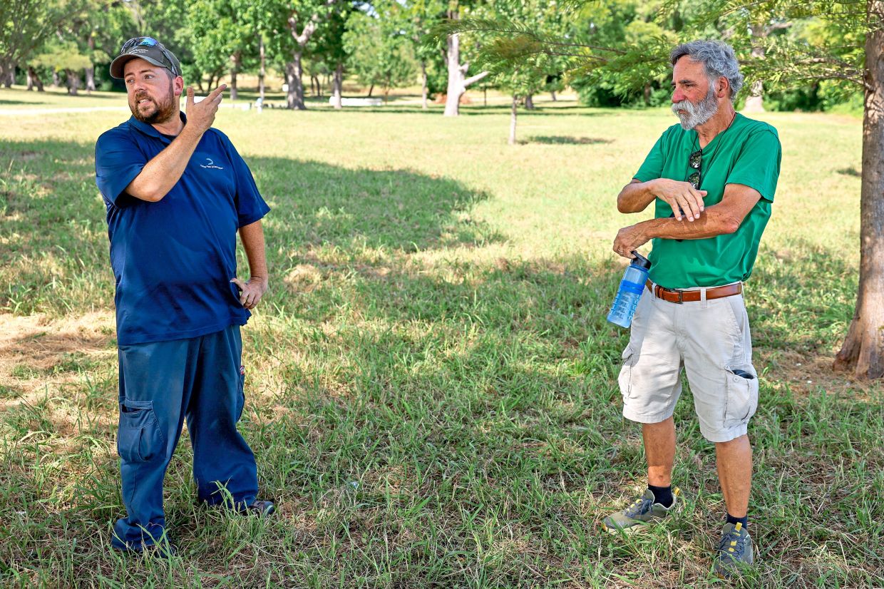 Morris talks with Dallas resident Dick Morrison while watching bald eagles and their eaglets at White Rock Lake.