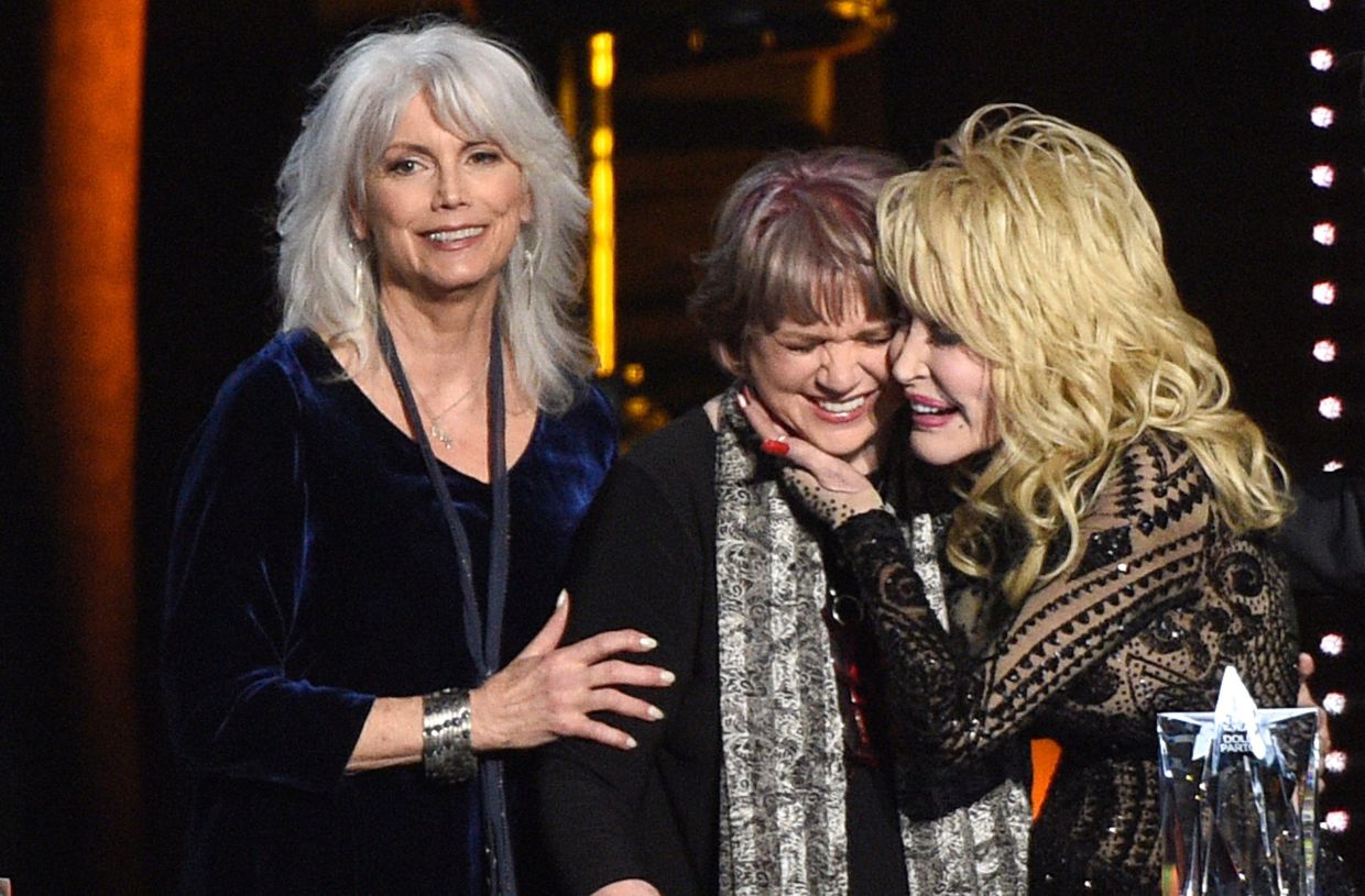 (From left) Emmylou Harris and Linda Ronstadt present Dolly Parton with the MusiCares Person of the Year award in Los Angeles on Feb 8, 2019. Photo: AP