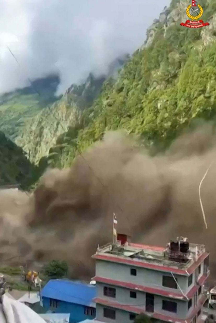 This frame grab from a UGC footage courtesy of Nepal Police shows floodwaters sweeping through houses along the Bhote Koshi River after flash floods in Rasuwa district on August 26, 2026. A massive flood swept through Nepal's northern Rasuwa district on August 26, damaging roads and power infrastructure as authorities scrambled to assess the scale of the destruction. - Photo: UGC / Nepal Police / AFP