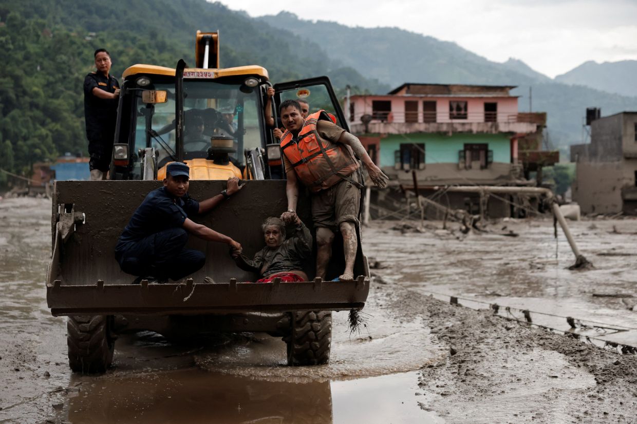 A survivor is transported to a safer place in a JCB following a flash flood at Trishuli in Nuwakot district, Nepal, August 26, 2026. - Photo: Reuters