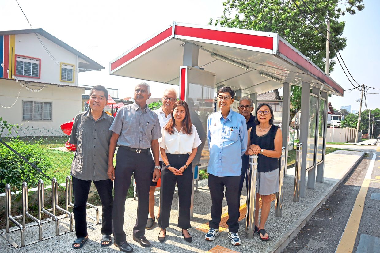 (Front row, from second left) Balachandran, Lim and Ong with other residents at the newly relocated bus stop in Taman Universiti, Petaling Jaya.