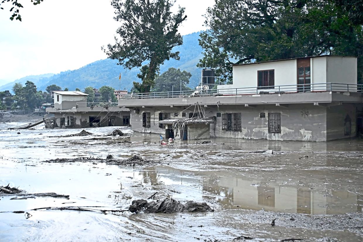 Major loss: Houses deluged in sludge after flash floods at Devghat in Nepal’s Nuwakot district. — AFP