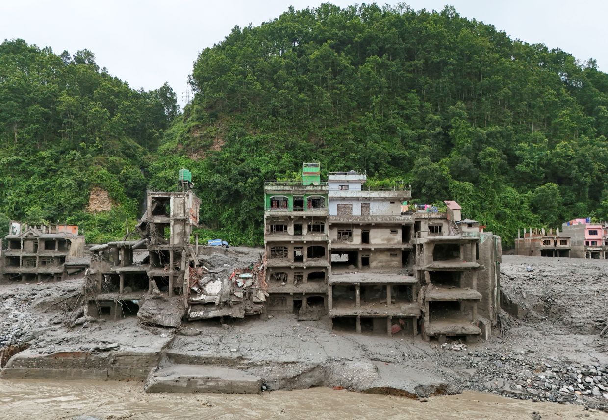 A drone view shows mud covering properties following the flash flood in Trishuli on Aug 27, 2026. - Reuters