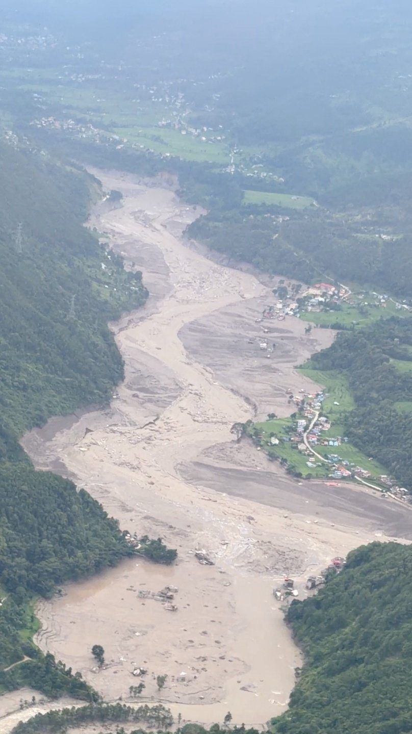 A muddy area viewed from a helicopter, in the aftermath of flash floods, in Rasuwa district, Nepal on Aug 26, 2026 in this still image obtained from social media video. - Pradip Pandit/Alpine Kailash Trek Pvt Ltd/via Reuters
