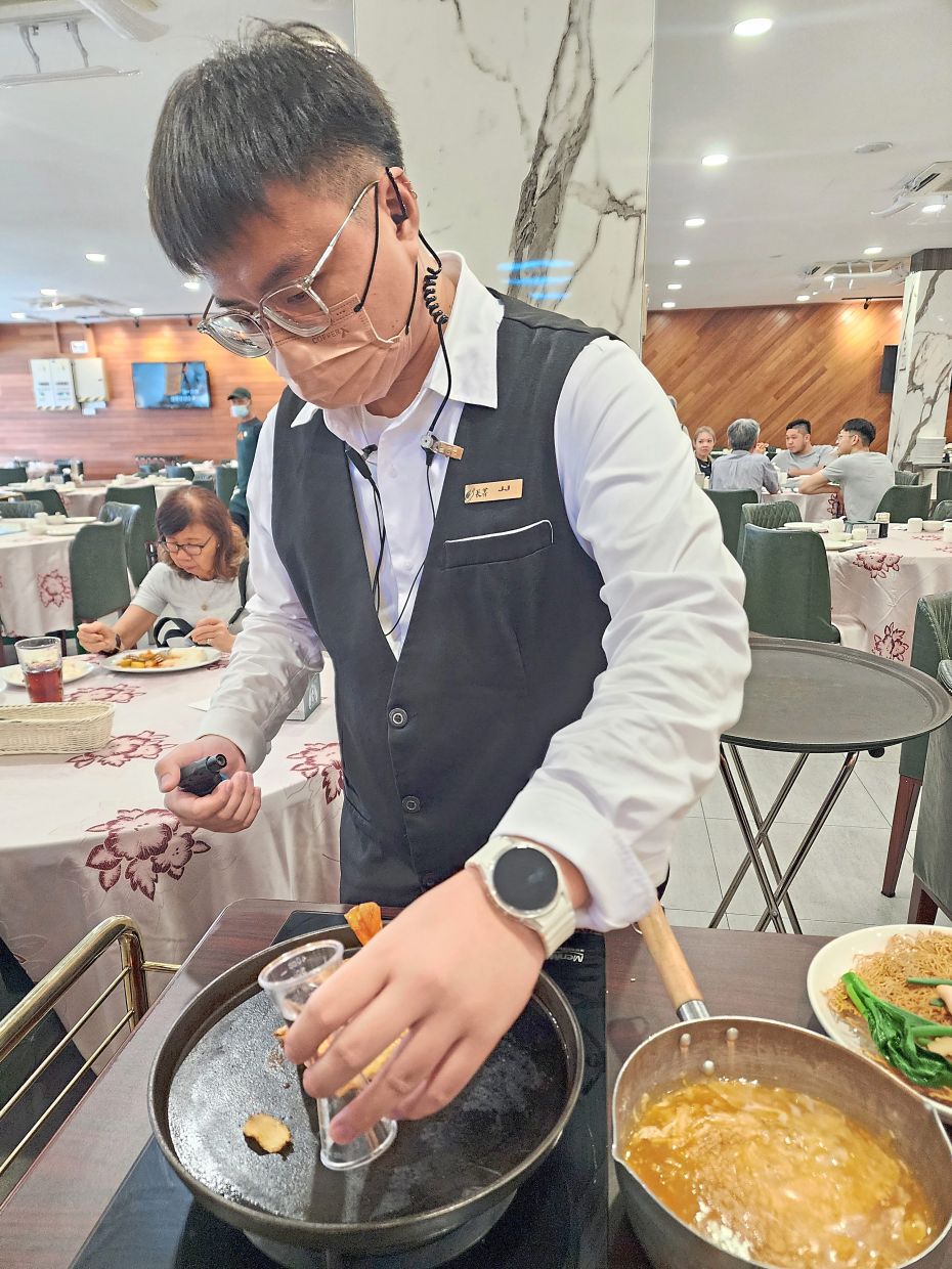 The moutai sang har mee is made table-side at the restaurant for a bit of visual theatrics.