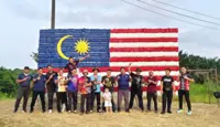 Mersing police personnel turn 1,400 used bottles into giant Jalur Gemilang