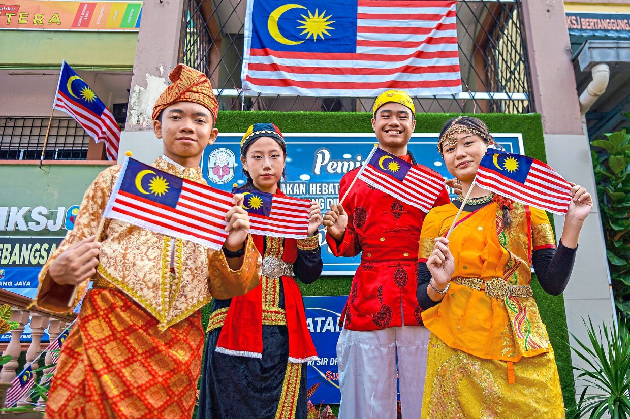 Students from SMK Subang Jaya, Selangor, showcasing traditional attire during an event marking National Day and Malaysia Day.
