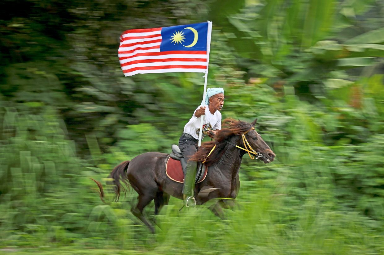 Nordin Mat, 61, from Kampung Seri Pulau in Kota Baru, Kelantan, galloping freely during a horseback parade involving 20 mounts.