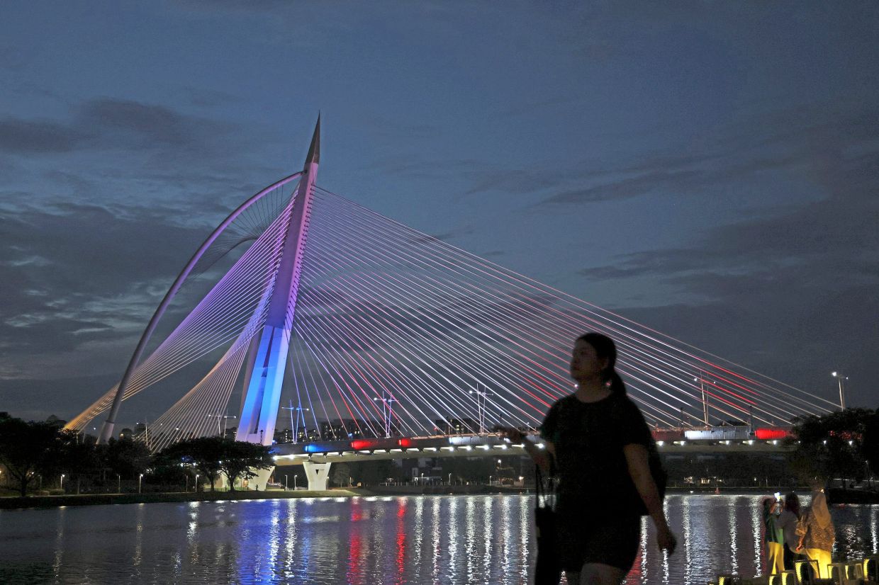Seri Wawasan bridge in Putrajaya lit up in red, white, blue and yellow for National Month. The administrative capital will host the official National Day celebration on Aug 31.
