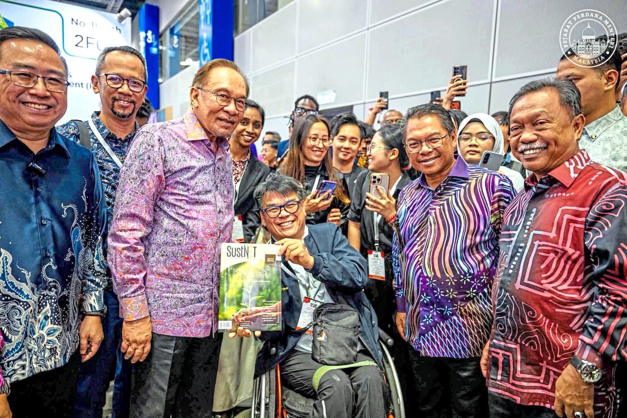Innovation push: Anwar (second, left) posing with attendees during his visit to the National Innovation and Commercialisation Expo 2026. — Photo from Anwar’s Facebook page