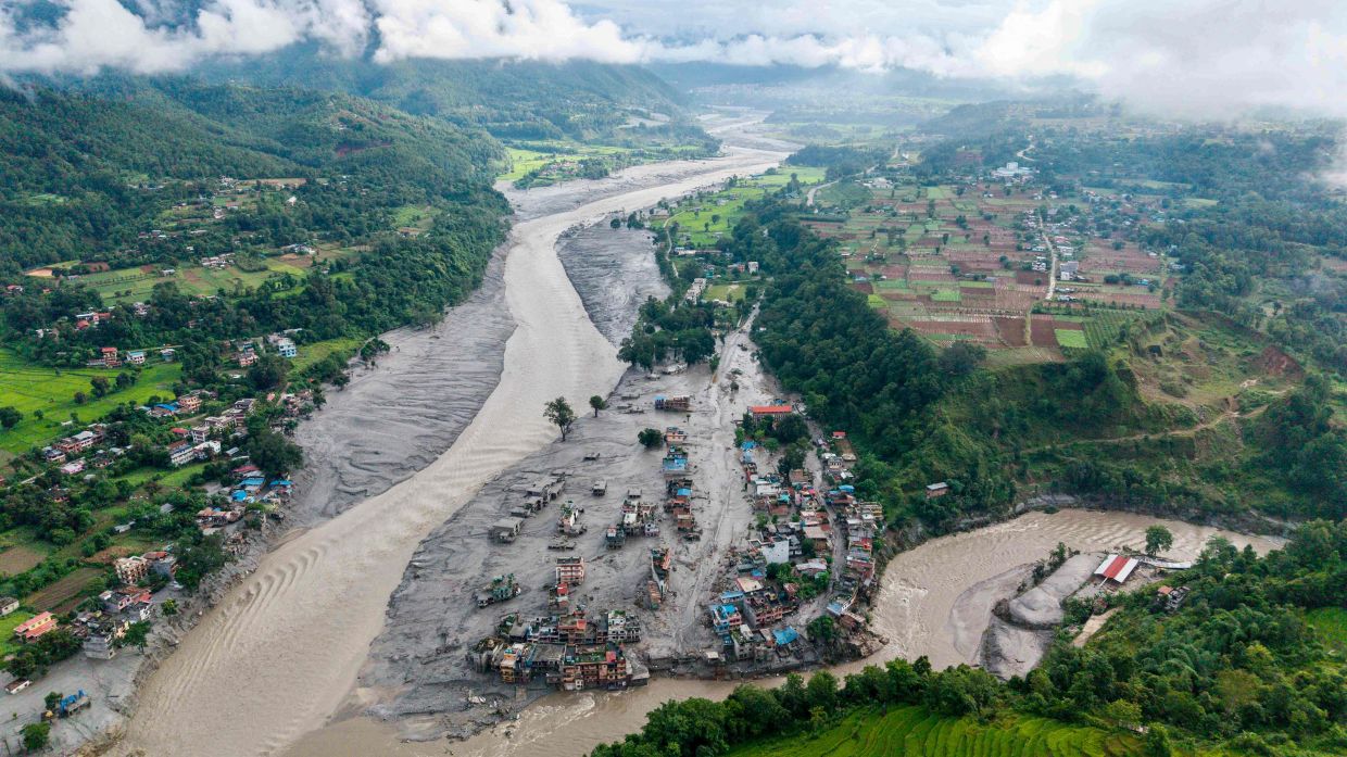 An aerial view shows houses lying deluged in sludge after flash floods at Devighat, Bidur Municipality on Aug 27. - AFP