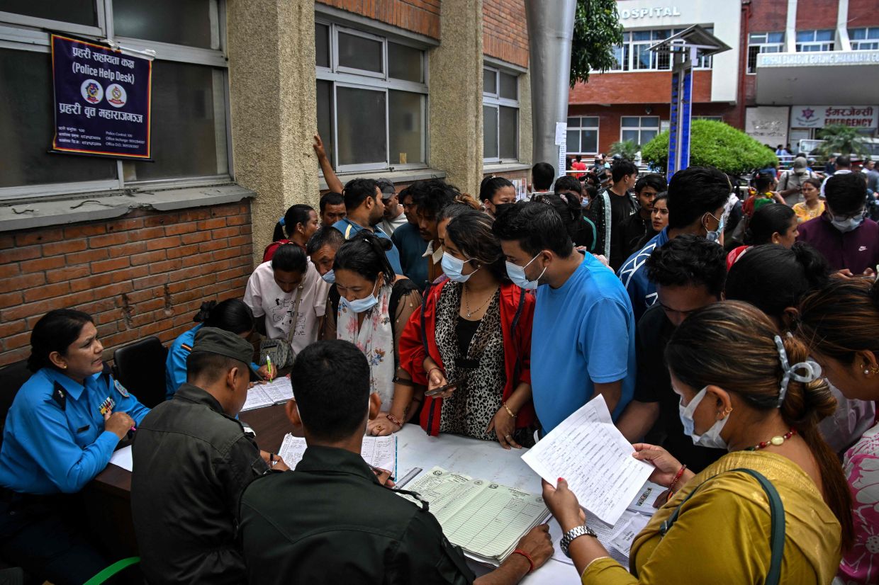 Relatives gather to enquire about missing people following flash floods in Nepal, outside a hospital in Kathmandu on Friday, August 28, 2026. Nepal ordered rescuers searching for survivors of deadly floods to get to safety as it reported a debris dam had burst in Tibet on August 28, bringing risks of new torrents. More than 1,400 people are missing, including trekkers in the Himalayas and scores of Hindu pilgrims to Tibet's sacred snow-capped Mount Kailash. -- Photo by Prakash MATHEMA / AFP