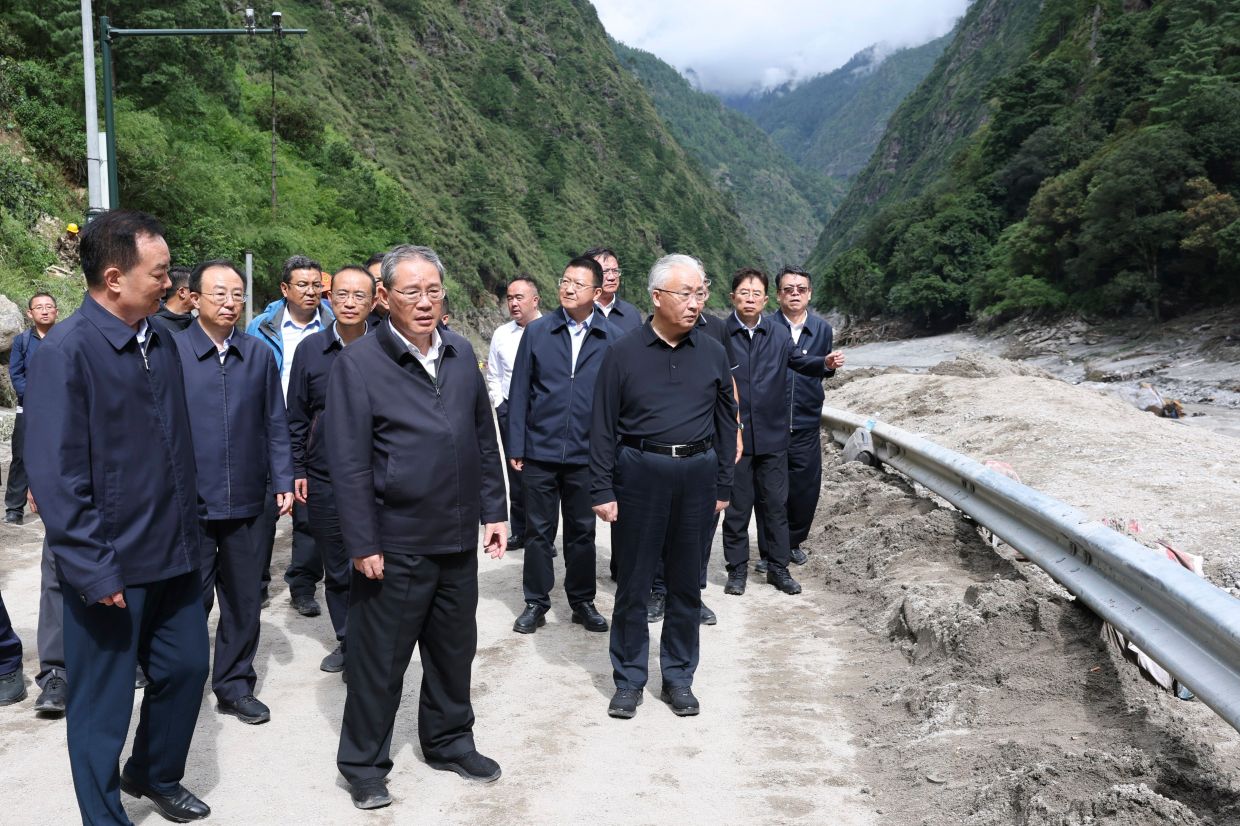Chinese Premier Li Qiang (fifth from left) inspecting a mudslide-hit area in Gyirong County on Aug 27, 2026. -AP