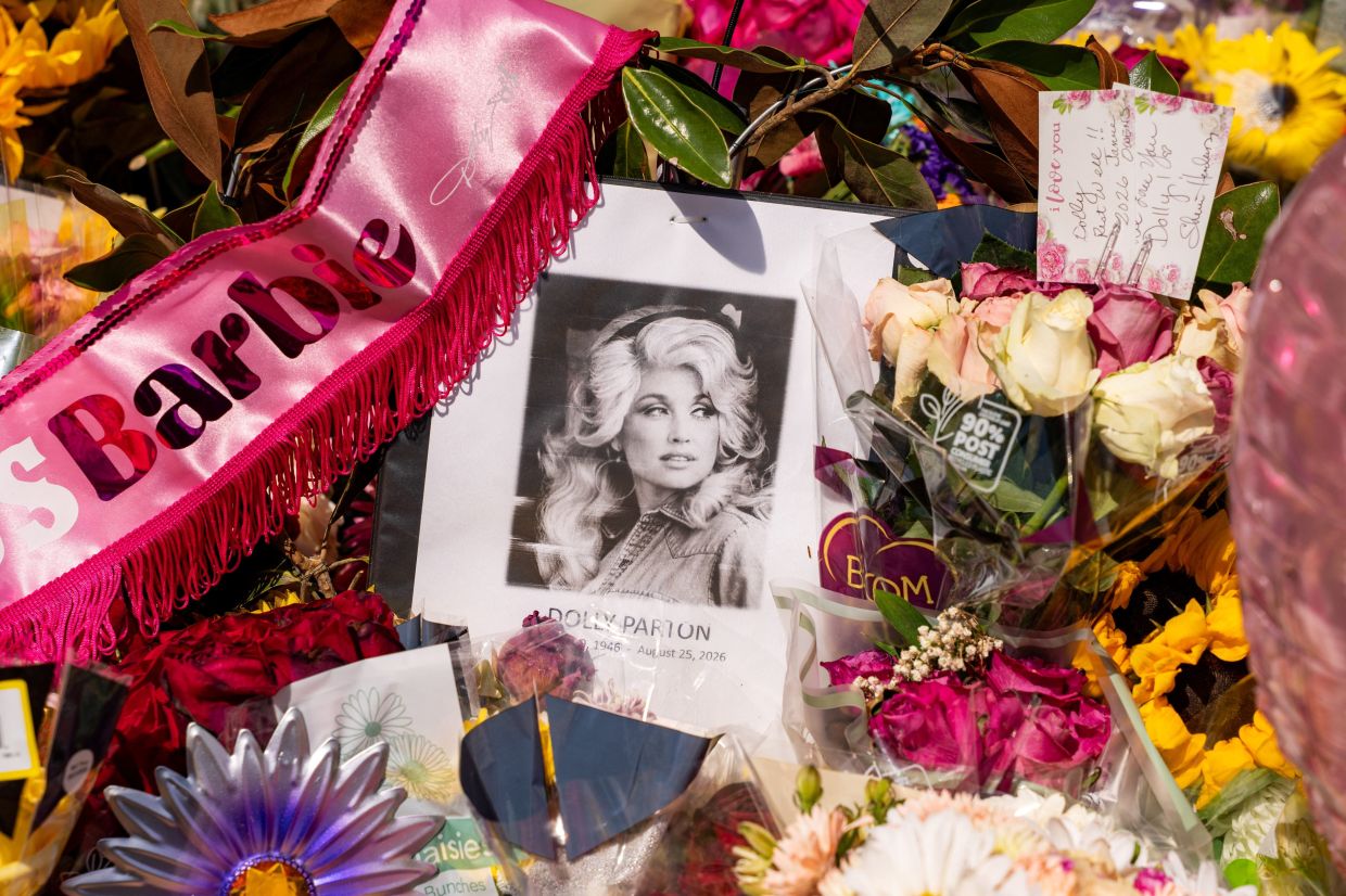 Flowers and other items in memory of Dolly Parton are left at the entry gate of Parton’s home following the passing of the country music icon. Photo: Reuters