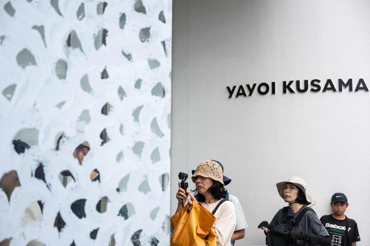 Visitors line up outside the Yayoi Kusama Museum in Tokyo on Aug 27. Photo: AFP