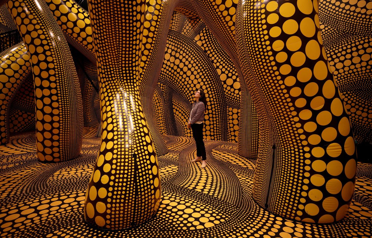 A visitor walks through a part of Kusama's installation 'You, Me And The Balloons' at the Manchester International Festival in Manchester in June 2023. Photo: Reuters