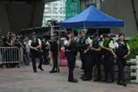 Hong Kong woman arrested for allegedly wearing seditious T-shirt outside court