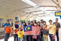 Jalur Gemilang adds National Day spirit to Penang-Kedah train commuters
