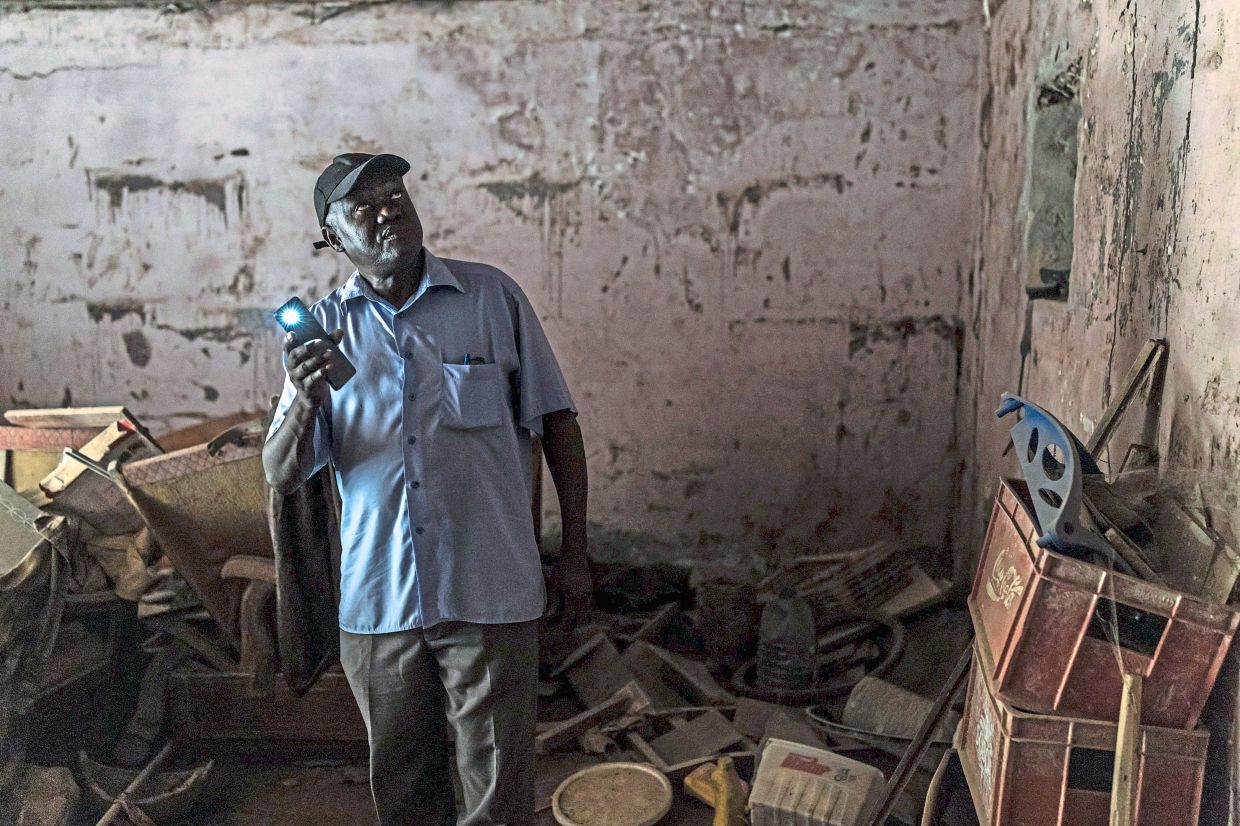 Diallo showing the inside of an old cell.