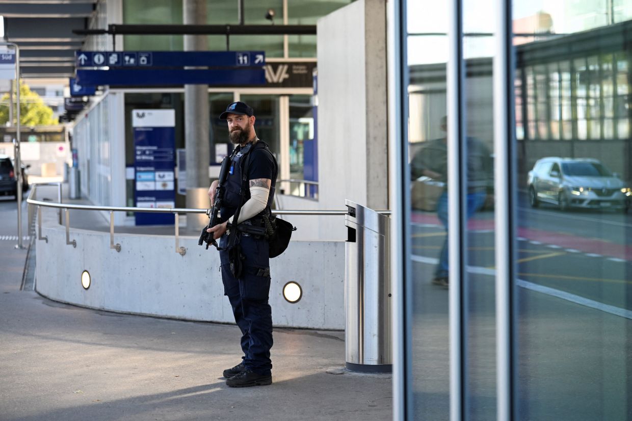 A police officer stands near the site of a deadly shooting at an event, according to the police, at a train station in Aarau, Switzerland, August 30, 2026. REUTERS/Romina Amato