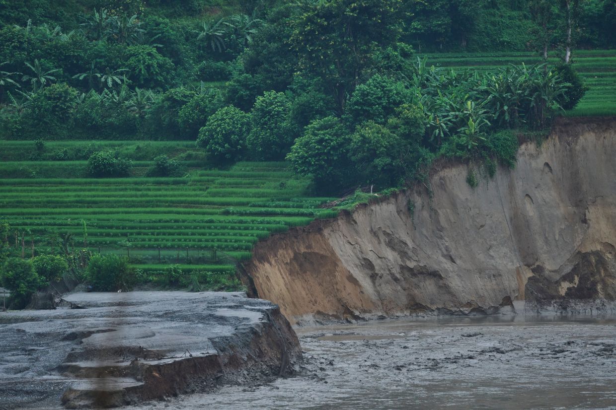 Flash flood-damaged farmland is seen on the bank of the Trishuli River in Dhading district, Nepal, on Sunday, Aug. 30, 2026. -- AP Photo/Niranjan Shrestha