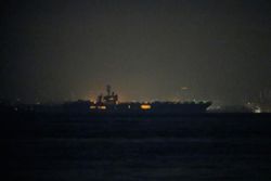 USS Abraham Lincoln sails past Singapore on its way home from Middle East