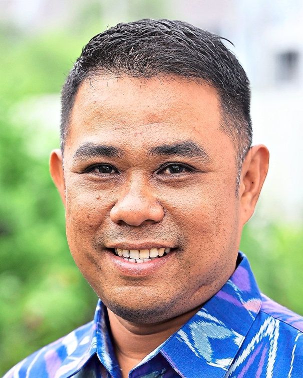 Mohd Khusairi says he wants his children to understand that the Jalur Gemilang also represents the sacrifices made by those who came before us.