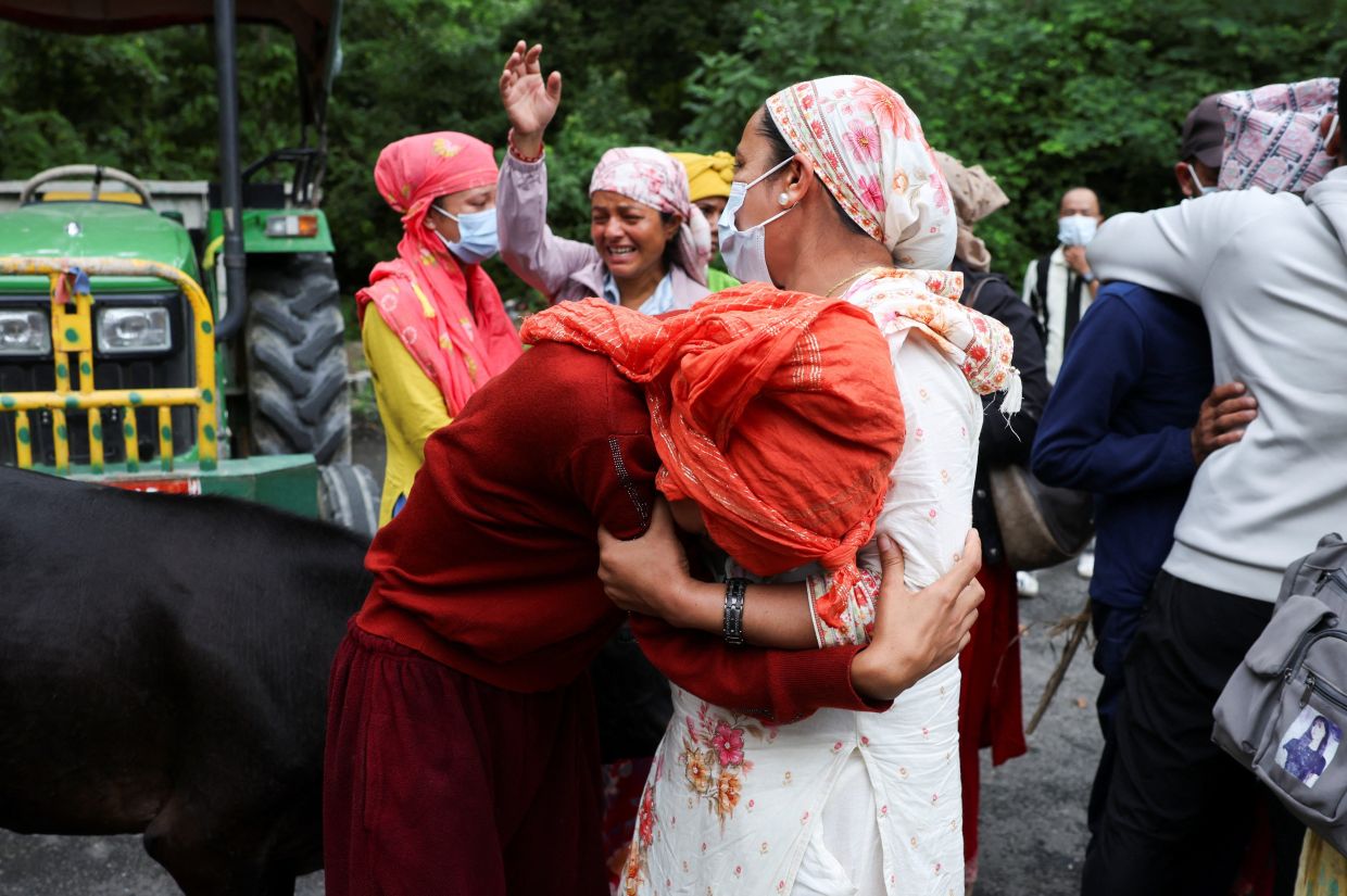 The mother and sister of Aayush Khadka, 21, who lost his life during the deadly flash floods and a mudslide, mourn outside a cremation ground, in Chitwan, Nepal, on Aug 31, 2026. - Reuters