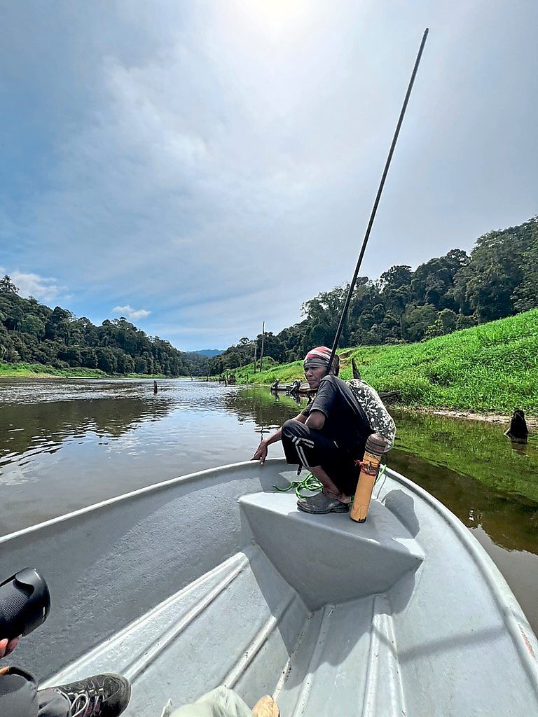 Reaching the Orang Asli settlement in Taman Negara involves a long journey by river.