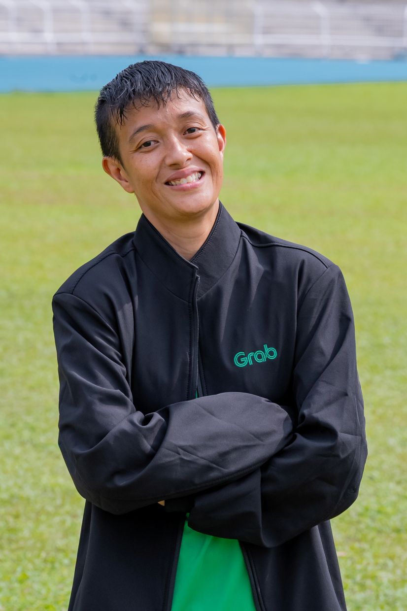 Grab delivery partner Syuhainie relies on flexible gig work to maintain financial independence and run her local burger business in Port Dickson.