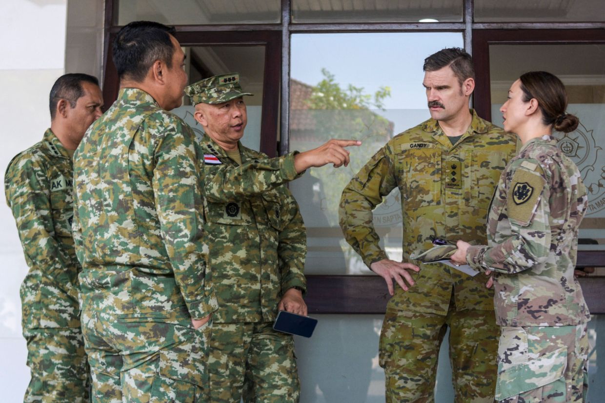 Colonel Dave Gandy, Australian Military Attache to Indonesia (second right) talks with military officers from Indonesian and the US after the opening ceremony of the Super Garuda Shield 2026 Joint Exercise in Bandung, West Java, on August 31, 2026. 4,700 soldiers from 21 countries armed forces participated in the Super Garuda Shield 2026 Joint Exercise which is held in several locations including Sumatra and Borneo islands. -- Photo by TIMUR MATAHARI / AFP