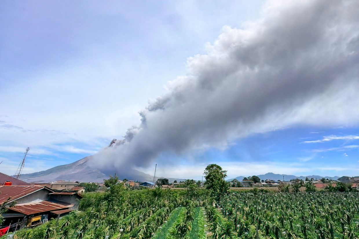This handout picture taken and released on Monday, August 31, 2026 by Indonesia's Center for Volcanology and Geological Hazard Mitigation shows volcanic ash billowing from Mount Sinabung after an eruption in Karo, North Sumatra. -- Photo by Indonesia's Center for Volcanology and Geological Hazard Mitigation / AFP