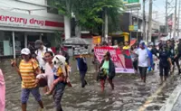 Central Luzon residents wade through floods to protest flood-control corruption in the Philippines