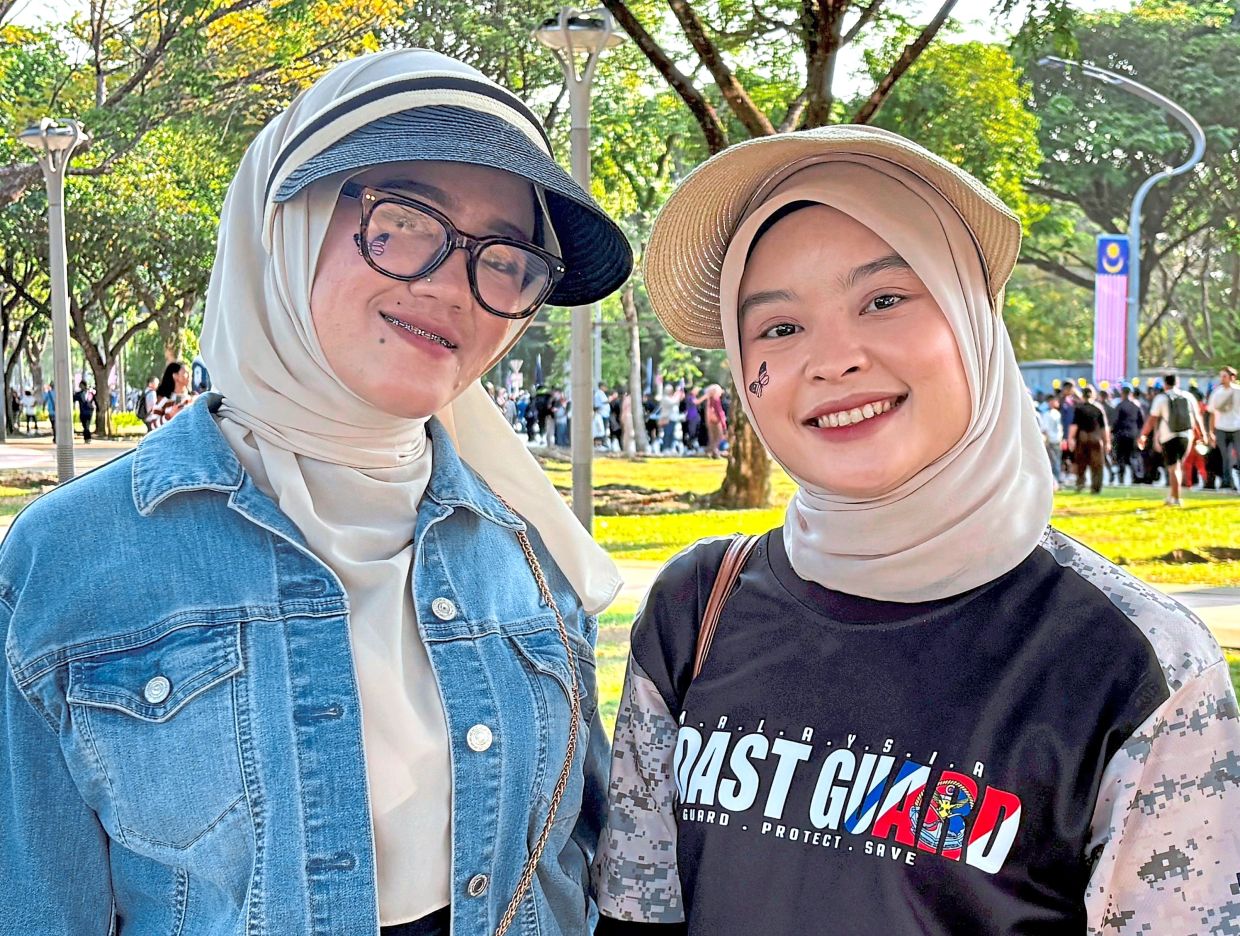 Friends (from left) Anis Aliaa Mohd Asri and Nadia Mohd Arshad, at the National Day parade.