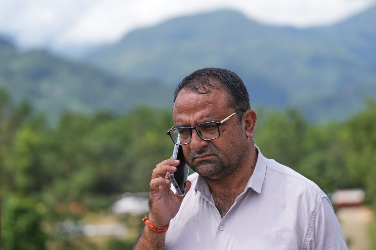 Rajendra Dawadi, a school teacher of Tribhuvan Trishuli Secondary School, talks on his mobile phone in Trishuli Valley in Nepal's Nuwakot district, Monday, Aug 31, 2026. - Photo: AP