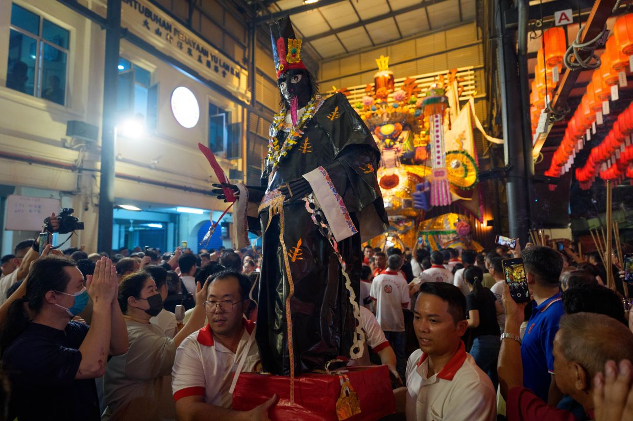 Participants carry a figure representing a Chinese deity during the Hungry Ghost Festival in Bukit Mertajam, Penang on Aug 29. Photo: AP